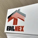 Il logo EdilNEX con la freccia rossa a forma di casa, in rilievo lucido sul fronte bianco soft touch del biglietto da visita