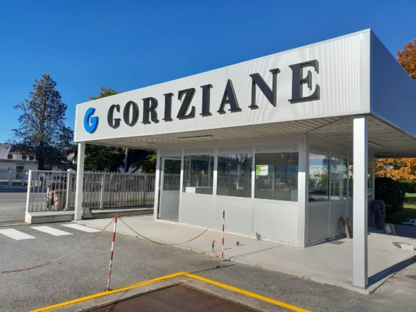 La pensilina della portineria di Goriziane a Villesse vista di lato, con il logo G blu e le lettere nere