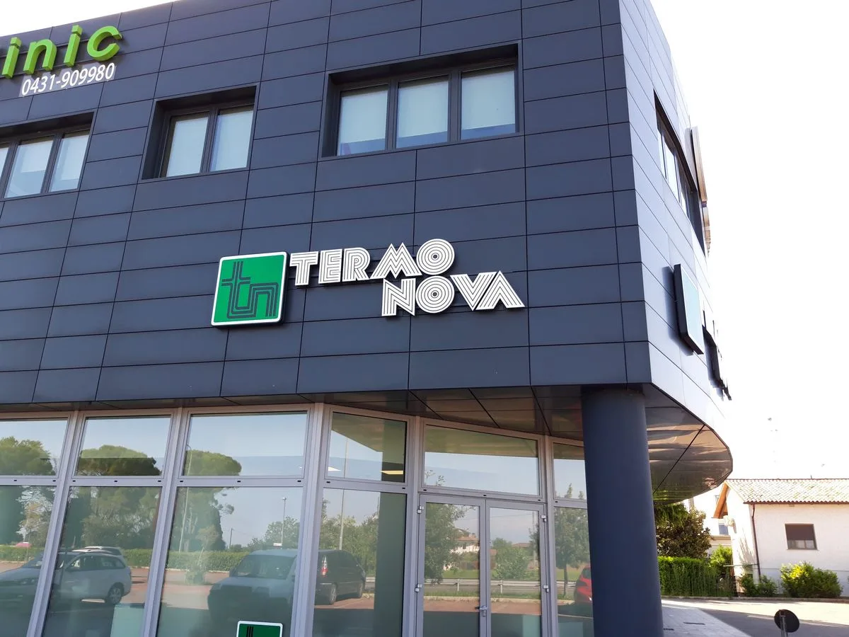 Dettaglio delle lettere singole bianche Termo Nova e del logo tn verde su pannello a Cervignano del Friuli